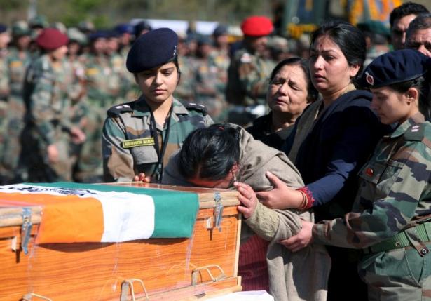 The mother of Tushar Mahajan, an Indian army officer who was killed in a gunbattle, weeps as she touches the coffin of her son Tushar during his wreath laying ceremony in Udhampur, north of Jammu, February 22, 2016. 