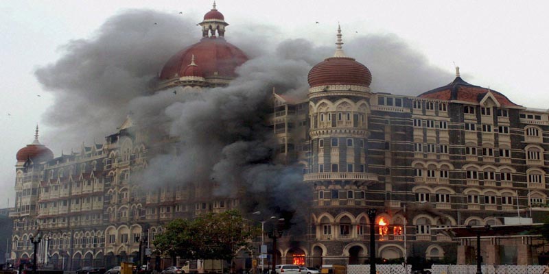 Mumbai: **FILE** Smoke is seen billowing out of the ground and first floor of the Taj Hotel in south Mumbai during security personnel's "Operation Cyclone" following the 26/11 terror attacks in 2008. Pakistani gunman Ajmal Amir Kasab, the sole surviving Pakistani gunman involved in the Mumbai attacks, was hanged to death at the Yerawada central prison in Pune on Wednesday morning. PTI Photo (PTI11_21_2012_000014B)