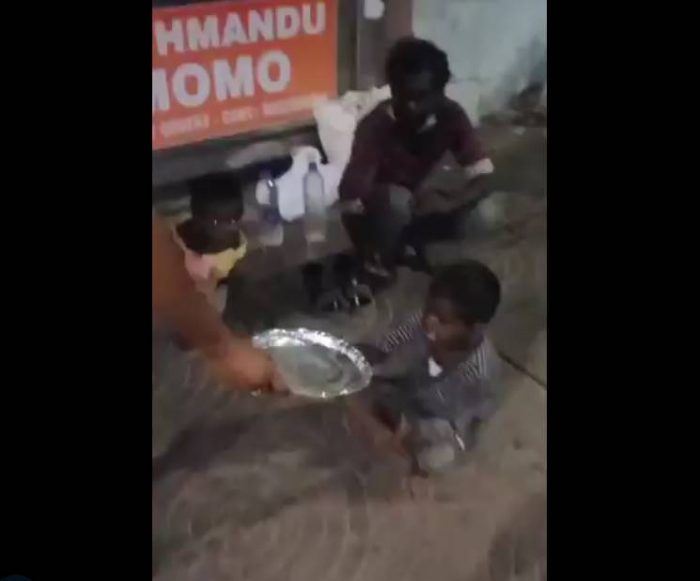 homeless boy eating food