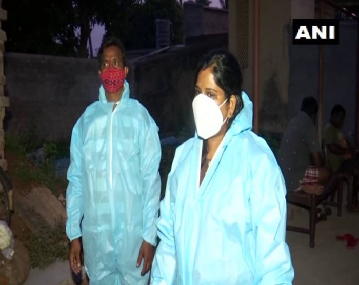 man woman in ppe kit