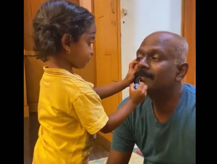daughter doing makeup of father 
